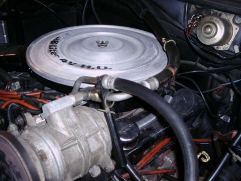 1984 Ford Bronco - Close-up of an engine compartment, focusing on the air cleaner assembly and associated hoses.