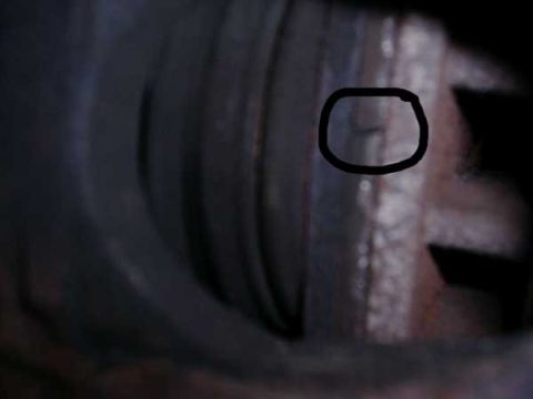 1988 Ford Bronco - Detail of a brake caliper, possibly showing signs of wear.