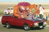 1972 Ford Ranchero - This pickup truck appears to be from the early 1970s, with a cartoon monster figure mounted on its roof.