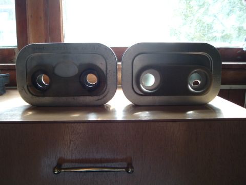2002 Harley-Davidson Sportster Custom - Two Harley-Davidson exhaust tips are shown, one with a part number stamped on it.