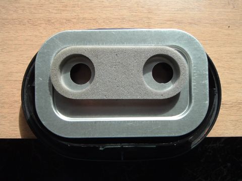 2002 Harley-Davidson Sportster Custom - This air cleaner assembly features a metal frame with a foam element containing two circular openings.