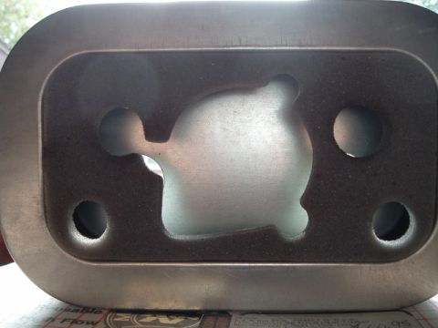 2002 Harley-Davidson Sportster Custom - This is a close-up view of a metal engine component with a unique internal shape.