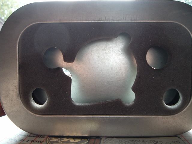 Close-up of a metal engine part with a cut-out shape