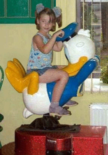 1992 Ford Probe - Child enjoys a ride on a Donald Duck themed amusement park attraction.