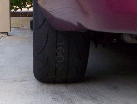 1992 Ford Crown Victoria - Close-up of a tire sidewall showing the number 1603 written in chalk.
