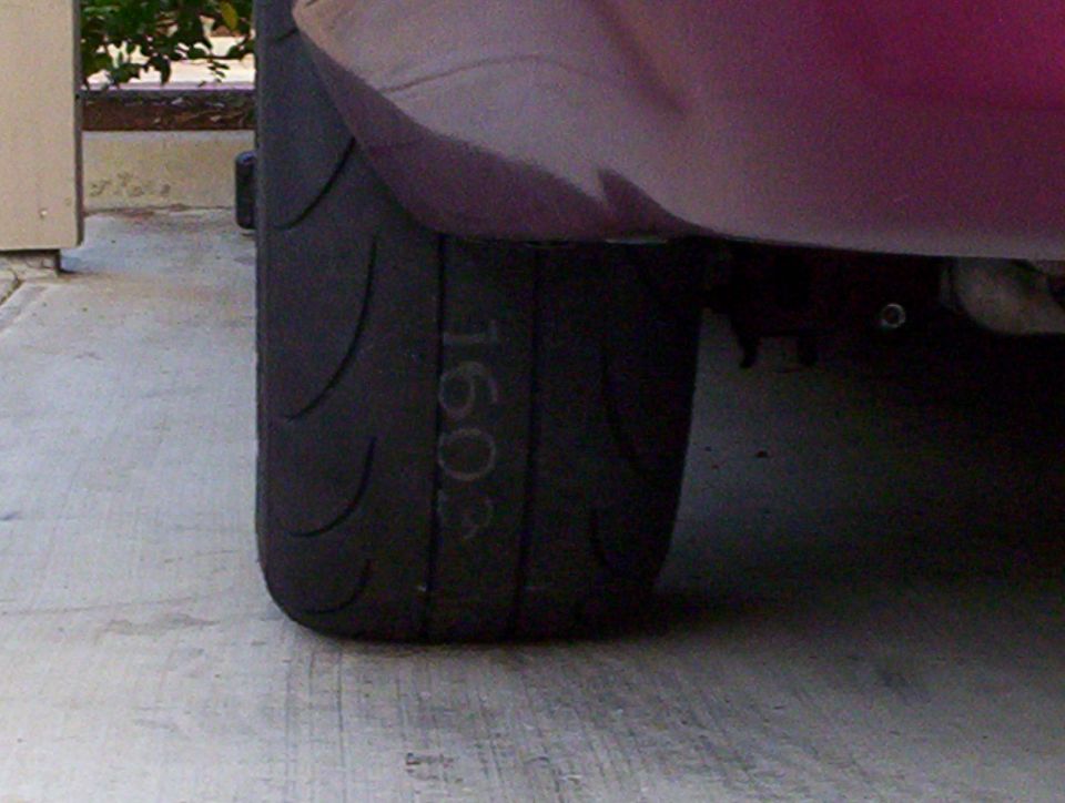 Tire sidewall with '1603' written on it, part of a car's wheel well