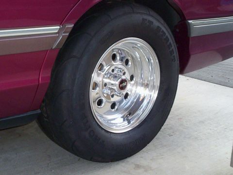 1992 Ford Crown Victoria - Close-up of a Weld drag wheel and drag radial tire on a car's rear quarter panel.
