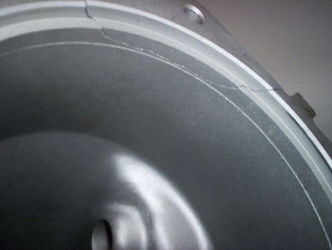 1992 Ford Crown Victoria - A close-up view of a damaged metal component, showing visible cracks along its rim.