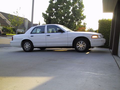 2003 Ford Crown Victoria - White 2003 Ford Crown Victoria parked in a driveway next to a garage.