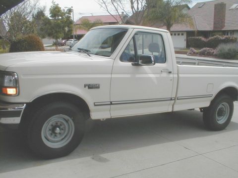 1992 Ford F-250 - This white 1992 Ford F-250 pickup truck is shown from the side, with the F-250 badge clearly visible on the fender.