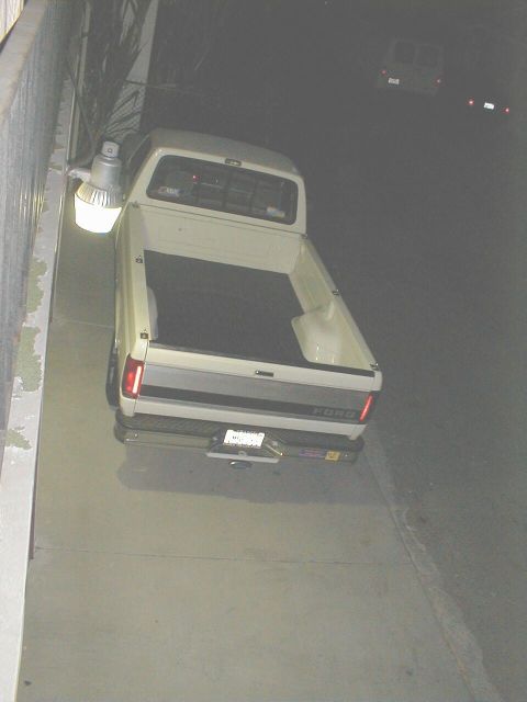1992 Ford F-250 - This 1992 Ford F-250 pickup truck is seen from the rear, parked at night.
