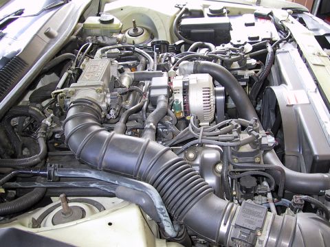 1997 Ford Thunderbird - Close-up view of a vehicle's engine bay, showing various components and wiring.