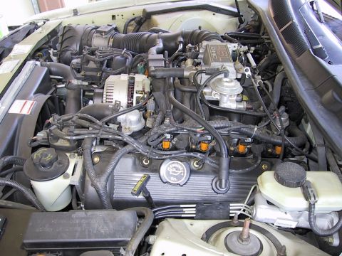 1997 Ford Thunderbird - The engine bay is shown, with a "4.6L DOHC" marking visible on the intake manifold.