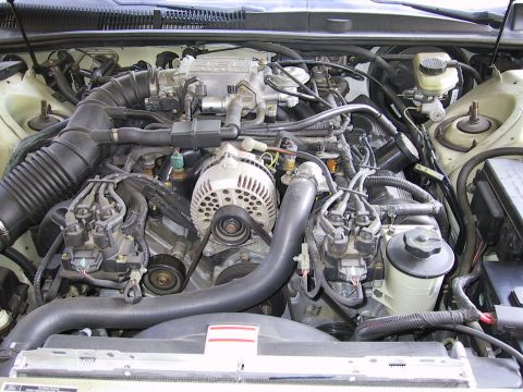 1997 Ford Thunderbird - Close-up view of a car's engine bay, showing various mechanical parts and wiring.