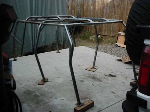 1978 Ford Bronco - Custom roll cage frame being fabricated outdoors on a concrete surface.