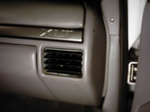 1978 Ford Bronco - Close-up of the interior dashboard trim, showing the XLT badge and an air vent.