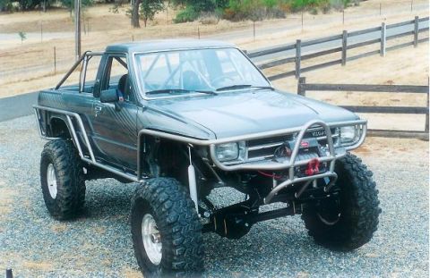 1991 Ford Bronco - This heavily modified Toyota pickup truck features a roll cage and off-road tires.