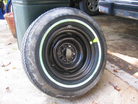 1985 Ford Crown Victoria LTD - A whitewall tire on a black steel wheel is shown, with another vehicle visible in the background.