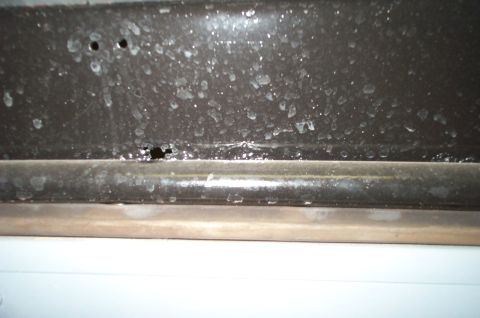 1954 Jeep Wrangler - Detail shot of a vehicle's lower body panel, showing damage and residue. The registry information may be inaccurate.