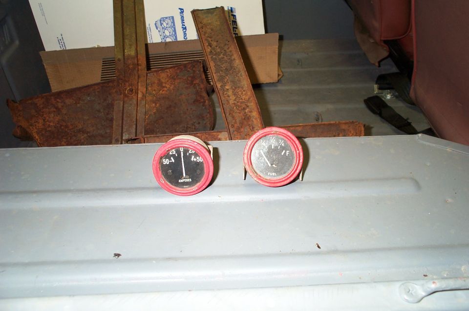 Ammeter and fuel gauge with red bezels on gray metal panel