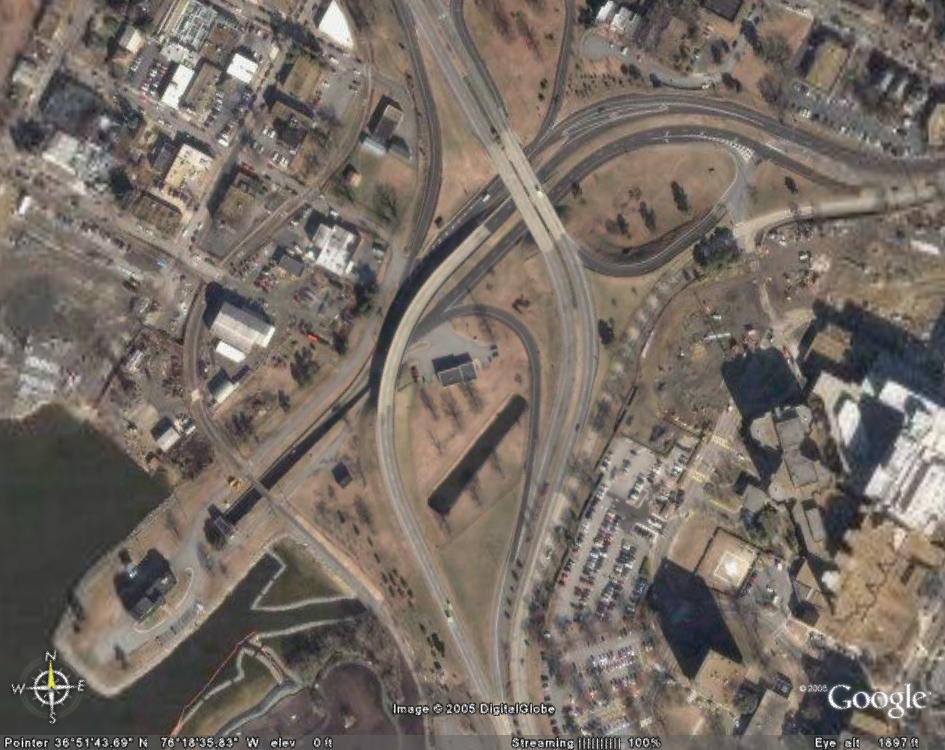 Google Earth aerial view of a highway interchange near a waterfront; no vehicle visible.
