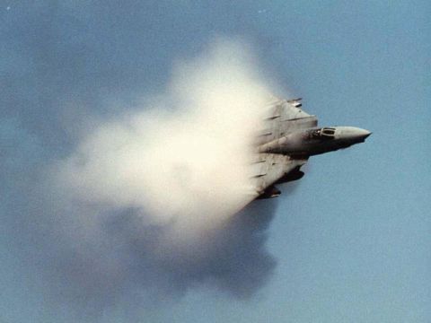 1987 Ford Bronco - A jet aircraft generates a visible shock cone as it exceeds the speed of sound in flight.