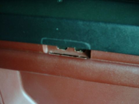 1984 Ford Bronco - Detail of a plastic clip on interior trim, likely from a vehicle.