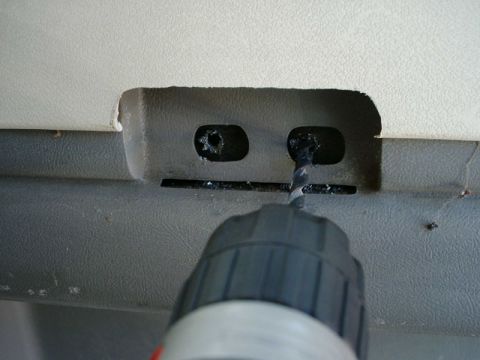 1984 Ford Bronco - Drilling into a vehicle's interior panel, likely for accessory installation.