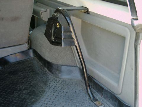 1984 Ford Bronco - A close-up view of the interior of a vehicle, focusing on a mounted accessory with visible markings.