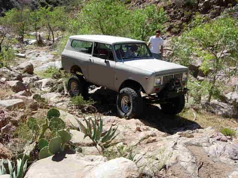 1981 Ford F-150 - An International Harvester Scout II navigates a , rocky terrain in a dry, vegetated canyon.