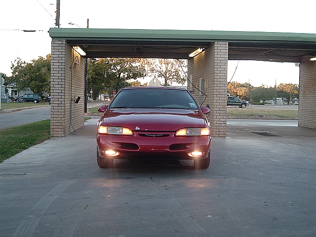 1994 Ford Thunderbird front view parked under a brick carport