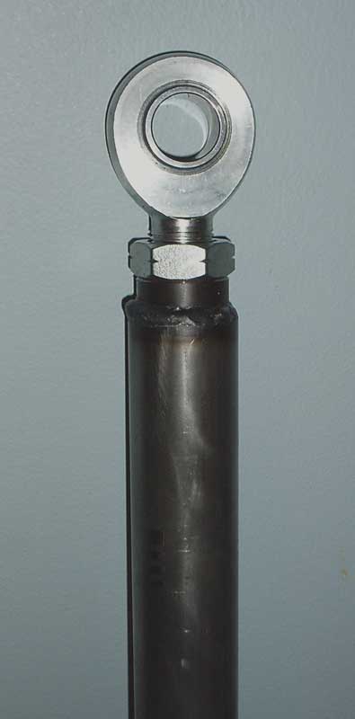 1996 Ford Bronco - A close-up view of a metal rod end bearing attached to a threaded shaft.