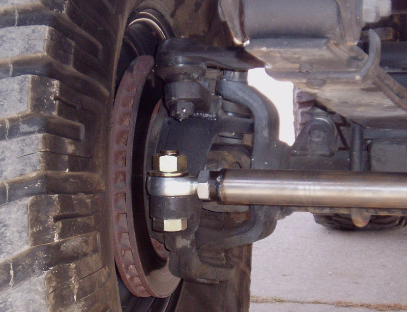 Close-up of a 4x4 front axle, brake rotor, ball joint and steering tie rod