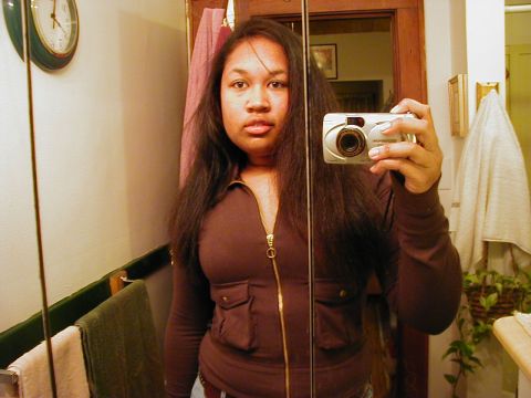 1997 Ford Taurus - A woman takes a selfie in a bathroom mirror, holding a digital camera.