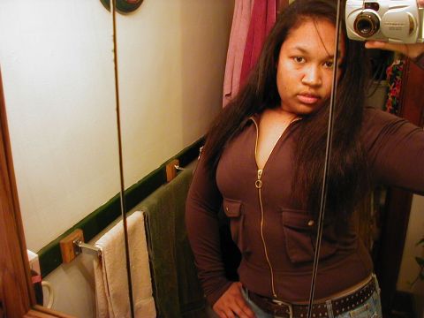 1997 Ford Taurus - A woman takes a selfie in a bathroom mirror, holding a digital camera.