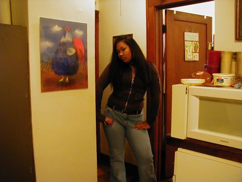 1997 Ford Taurus - A woman poses for a photo indoors, with a painting of a rooster on the wall behind her.
