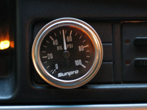 1995 Ford Bronco - A Sunpro oil pressure gauge is mounted on the dashboard, indicating the vehicle's oil pressure.