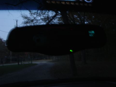 2000 Ford Taurus - Digital display on rearview mirror shows temperature and time, with a green light illuminated.