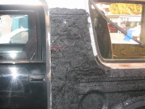 1991 Ford Bronco - A close-up shot focuses on a vehicle's bodywork, highlighting a textured panel and a door handle.