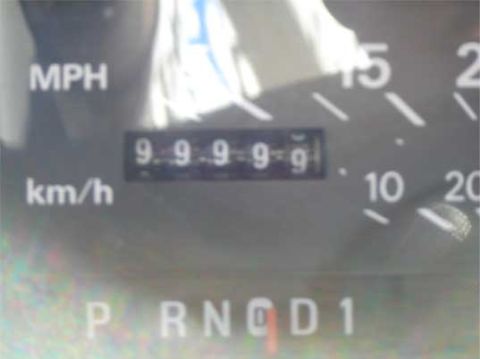 1988 Ford LTD Crown Victoria - The odometer shows 99999 miles, and the gear selector is in the Park position.