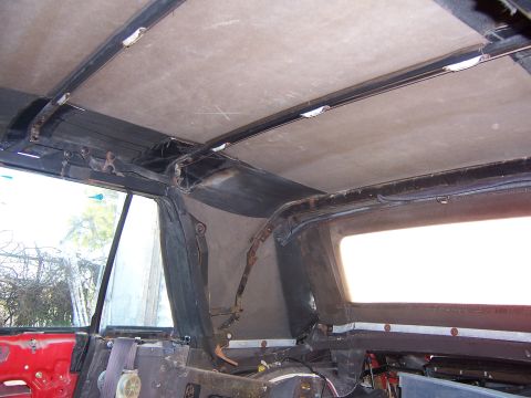 1984 Toyota Celica - Interior view of a car's roof structure and window frame, revealing exposed metal and fabric, suggesting a project or parts car.
