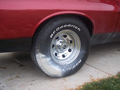 1972 Ford Ranchero - Close-up of a BFGoodrich Radial T/A tire and chrome rim on a red vehicle.