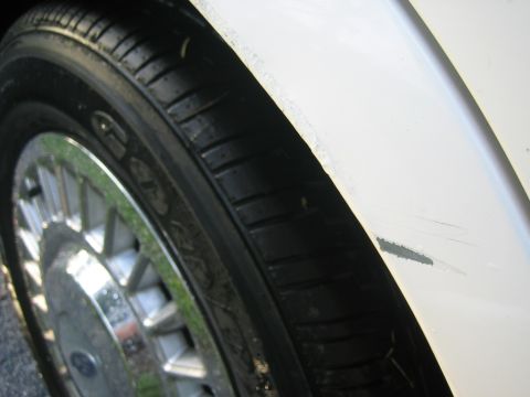 1999 Ford Crown Victoria - Paint chip near wheel on back passanger side.
