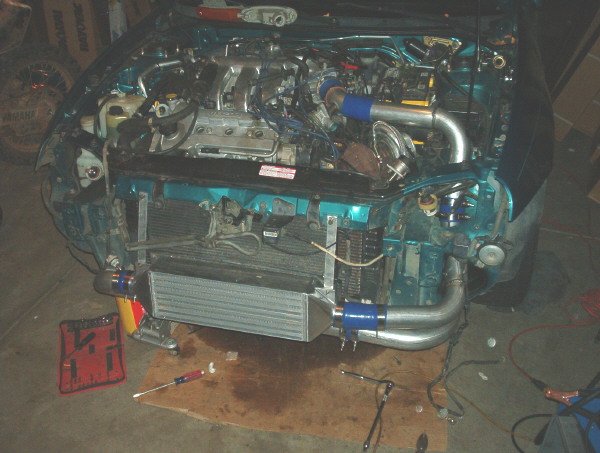 Engine bay with intercooler and turbo piping installed, front bumper removed