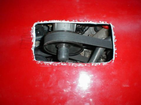 1992 Ford Probe - Engine belt and pulley visible through a cut-out in the red car's hood.