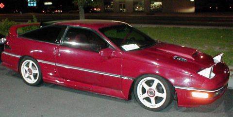 1992 Ford Probe - This red 1992 Ford Probe features pop-up headlights and distinctive white five-spoke wheels.