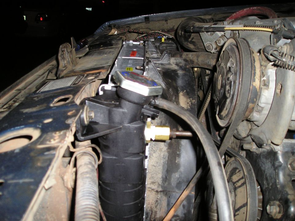 Close-up of a vehicle's engine bay showing a radiator and belts