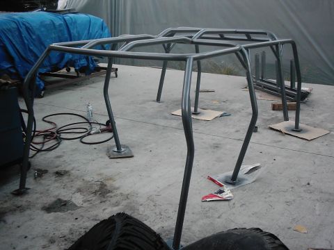 1978 Ford Bronco - A custom roll cage is shown on a concrete floor, possibly mid-project.