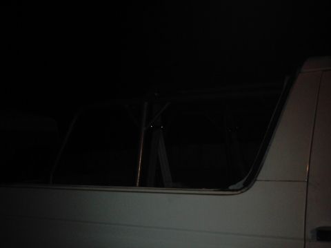 1978 Ford Bronco - Dark interior shot of a vehicle, possibly a Bronco, with visible roll cage supports.
