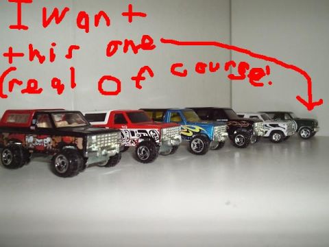1996 Ford F-150 - A collection of toy trucks are lined up, with a red arrow pointing to one of them and red writing above.
